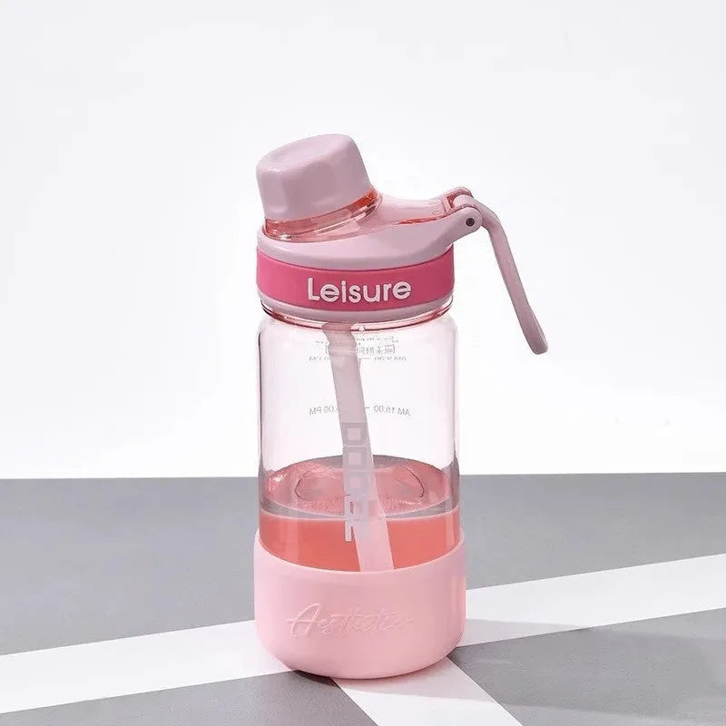 Cartoon pattern plastic straw cup in grey, green, or pink, showing heat-resistant and portable design.