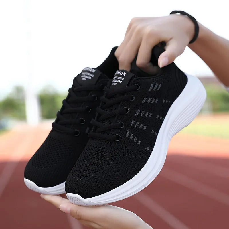 Women's black mesh breathable non-slip sneaker with lace-up front and flat heel, side view