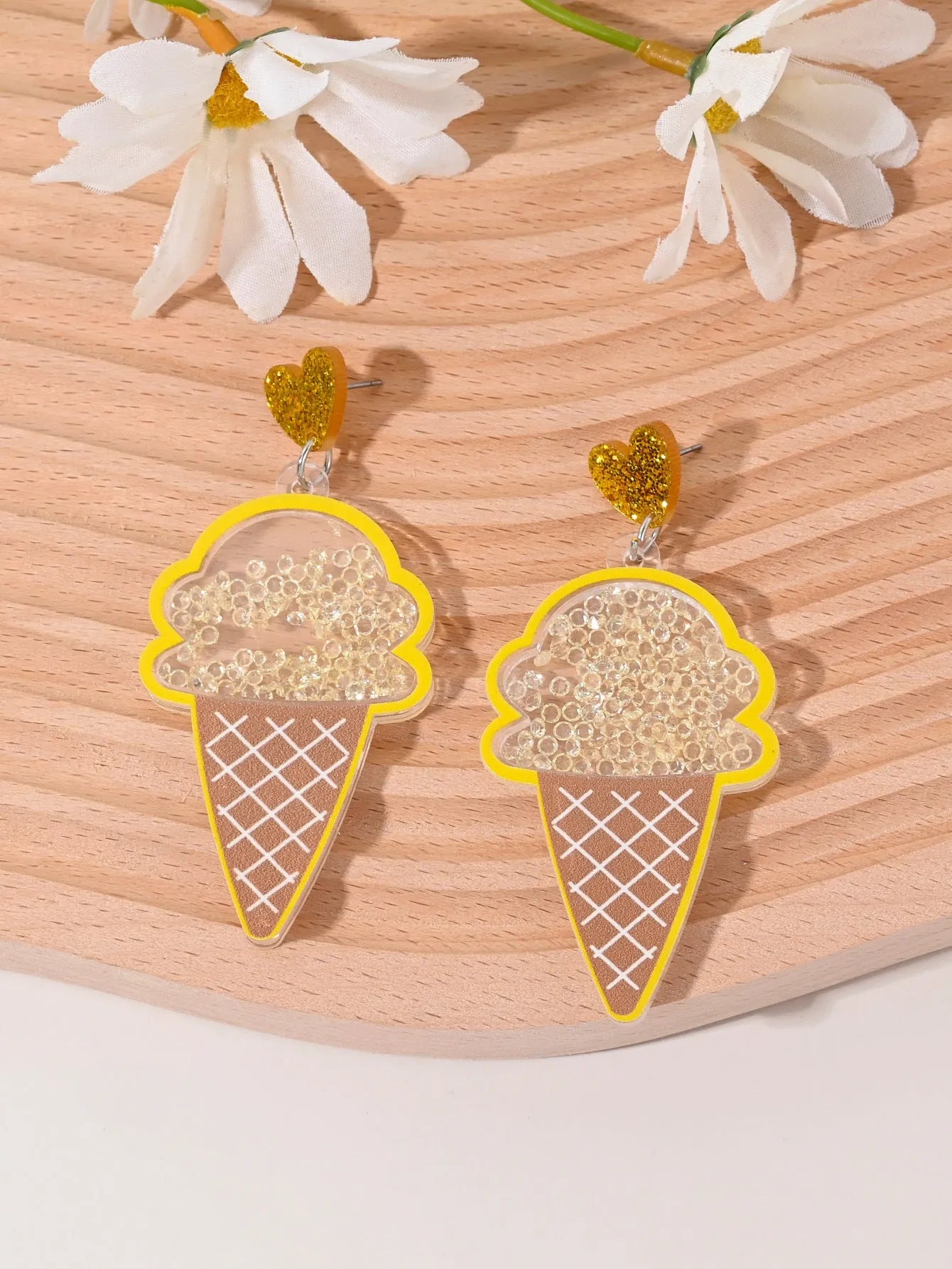 Colourful acrylic earrings with fruit and dessert designs including cherry, strawberry and watermelon shapes
