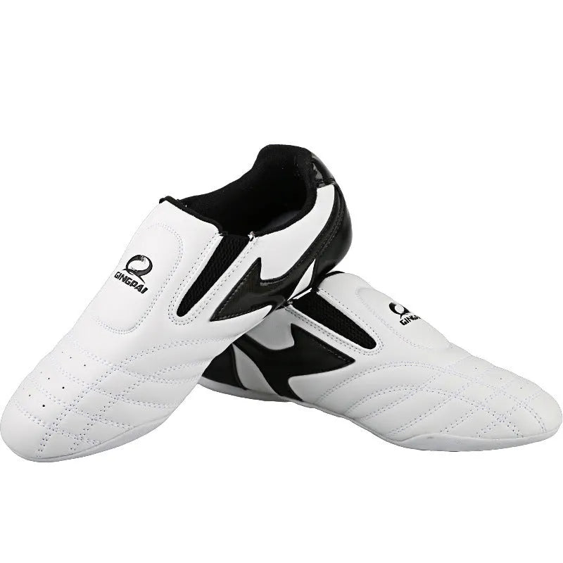 Black and white children's Sanda martial arts training shoes with a soft sole, shown with a shoe bag and socks.