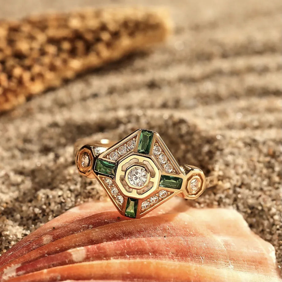 Square-shaped women's ring with a green emerald gemstone on a geometric band.