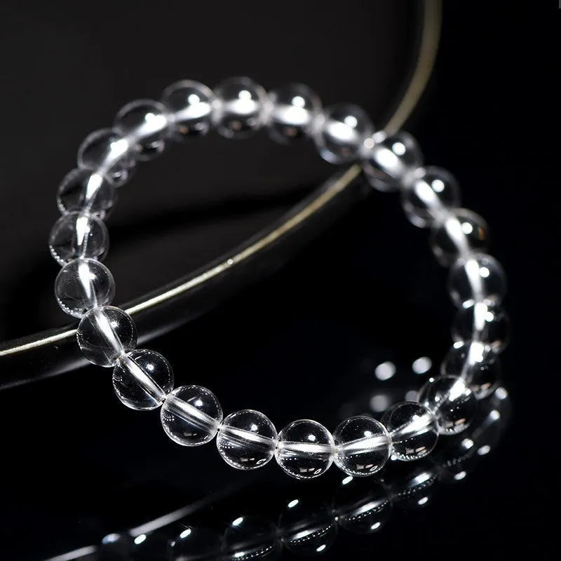 Natural Donghai old materials white water round bead crystal bracelet on a wrist, showing geometric design.
