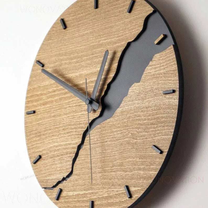 Modern simple wooden wall clock with crack design on a plain wall