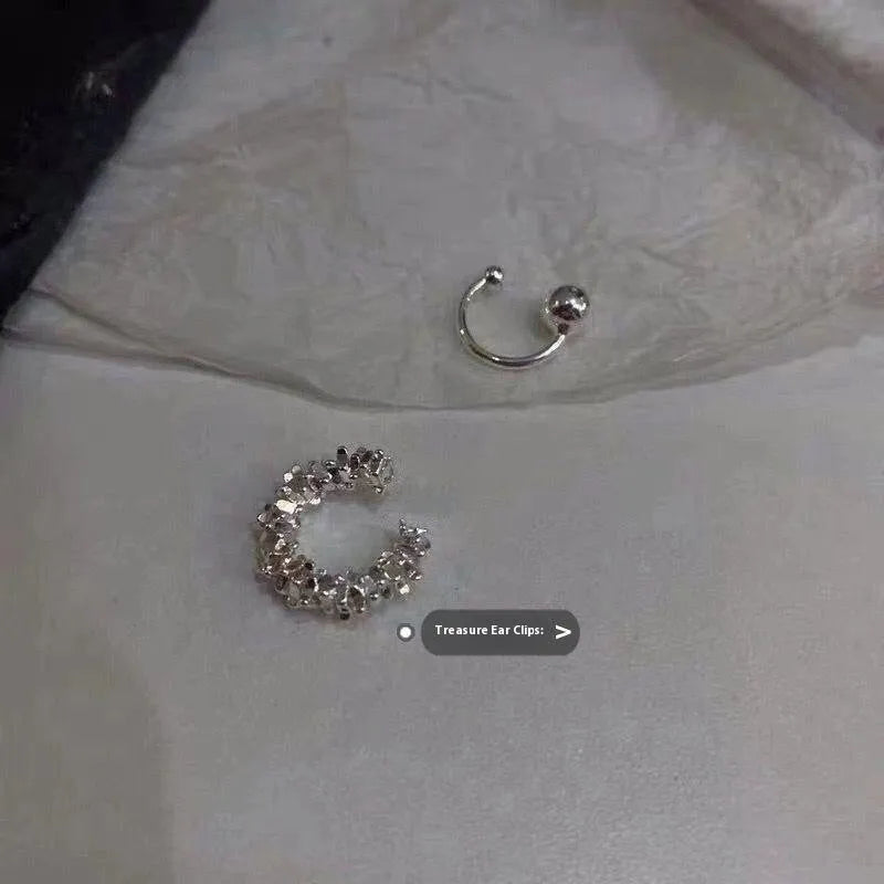 Pair of silver-toned geometric clip-on earrings with a frosty textured finish.