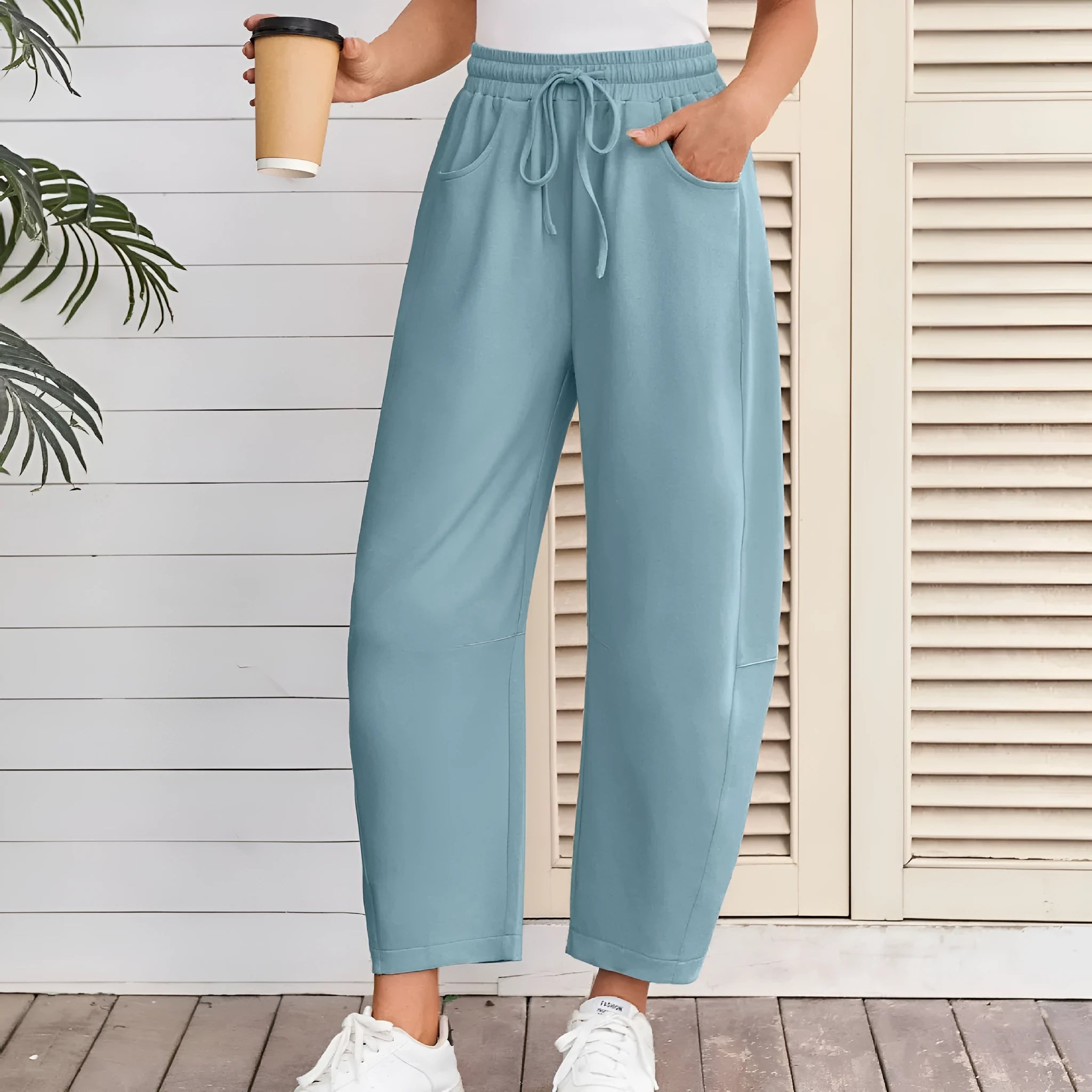 Women's loose cropped sweatpants with drawstring elastic waist and side pockets in street fashion style