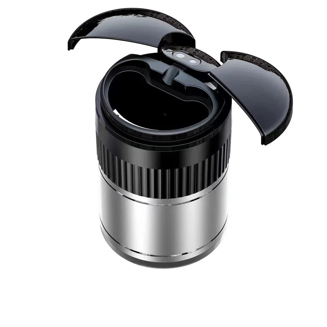 Black smart infrared metal car ashtray with lid on a car dashboard.