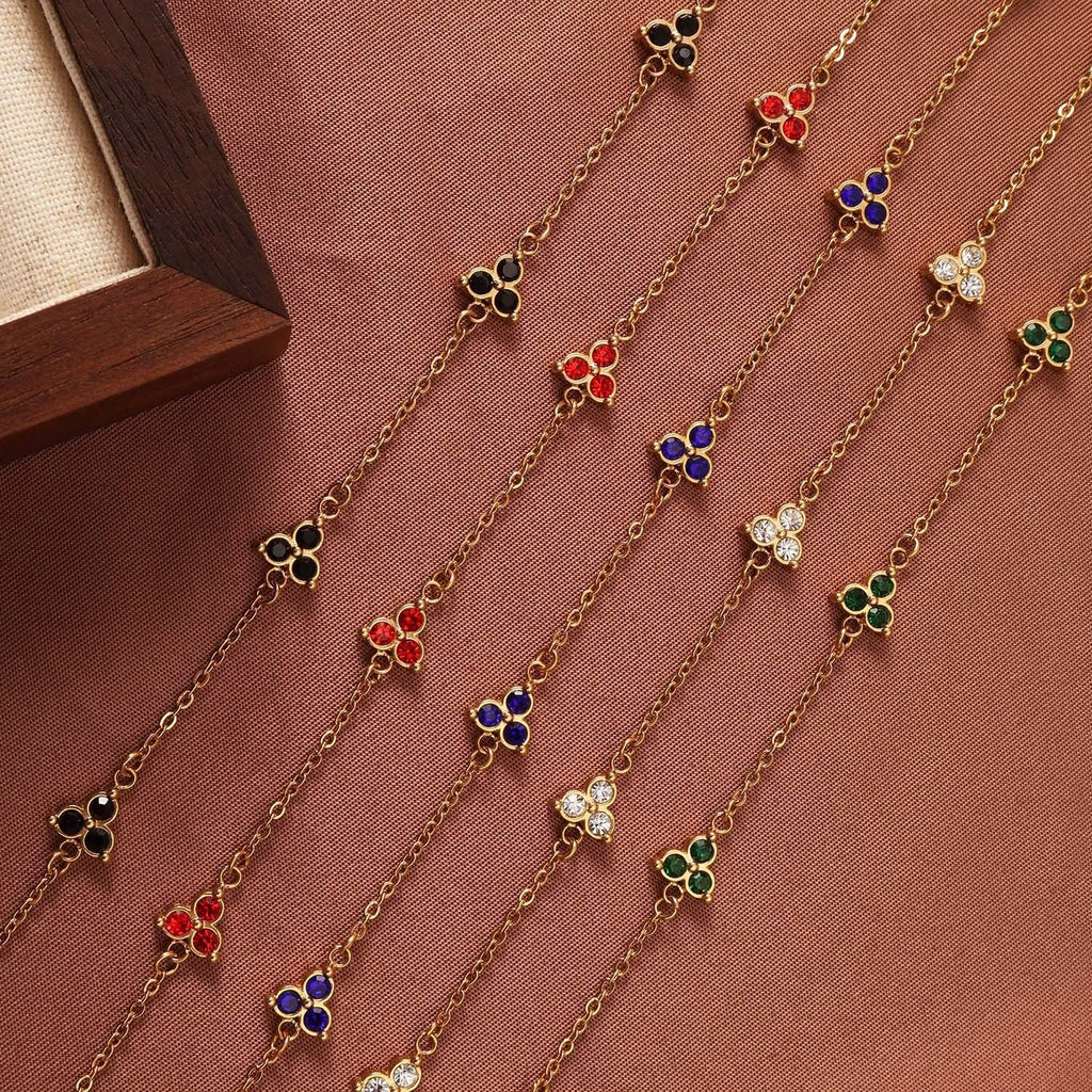 Women's stainless steel geometric bracelet with triangle details and a coloured stone setting.
