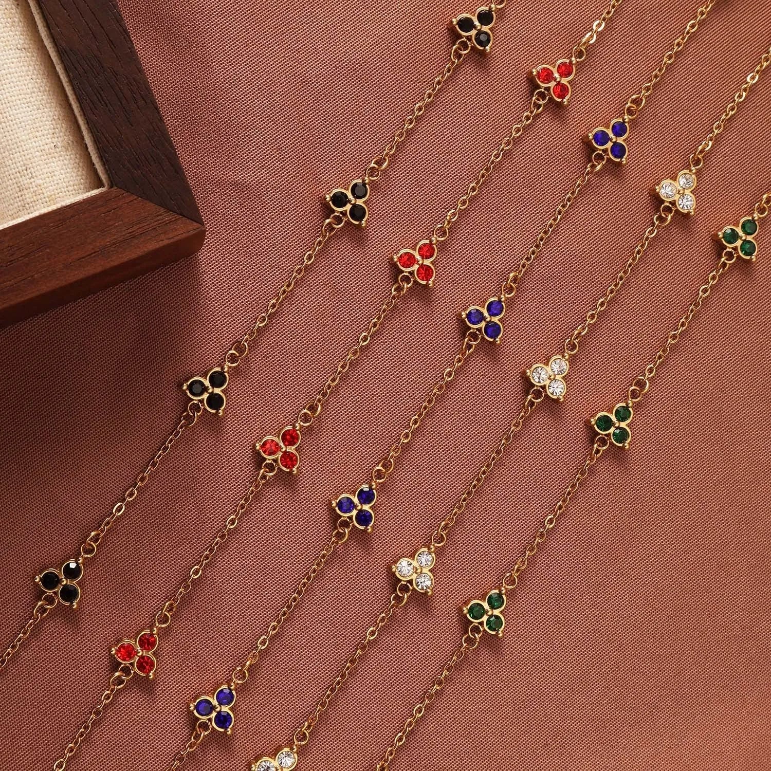 Women's stainless steel geometric bracelet with triangle details and a coloured stone setting.