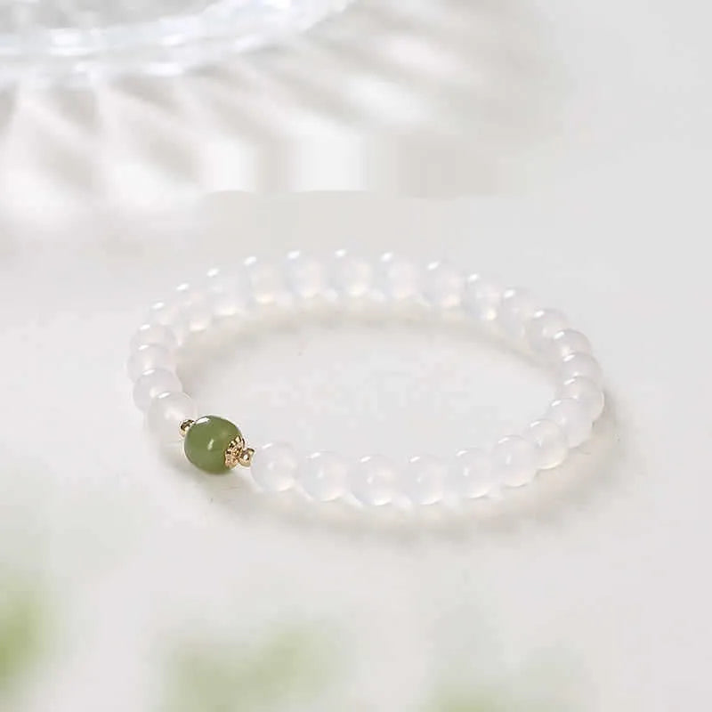 Handmade white agate and hetian jade bracelet with red cinnabar inlay forming text, shown in 6mm and 8mm bead sizes.