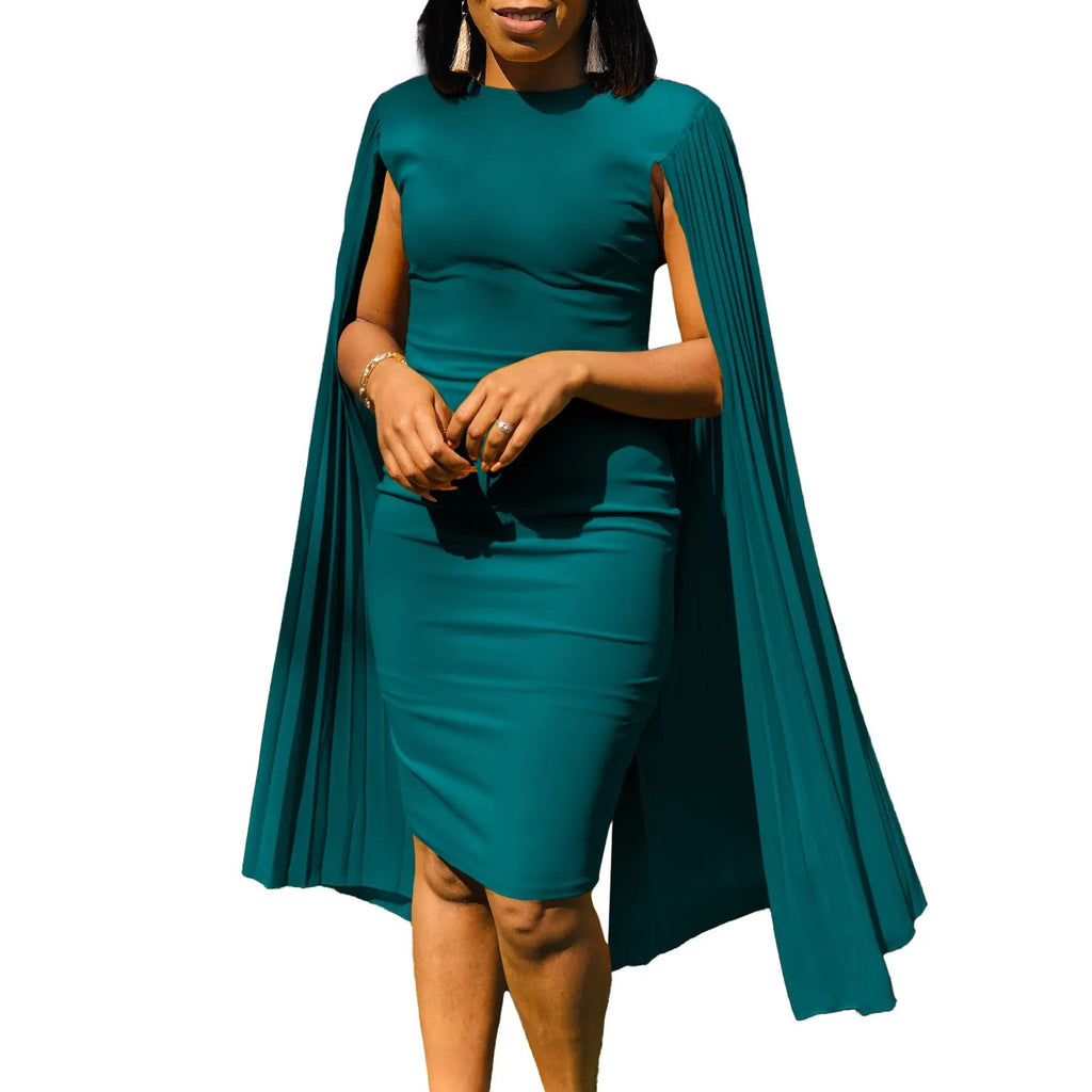 A model wearing a yellow high-waist evening gown with long sleeves and a pleated floor-length skirt.