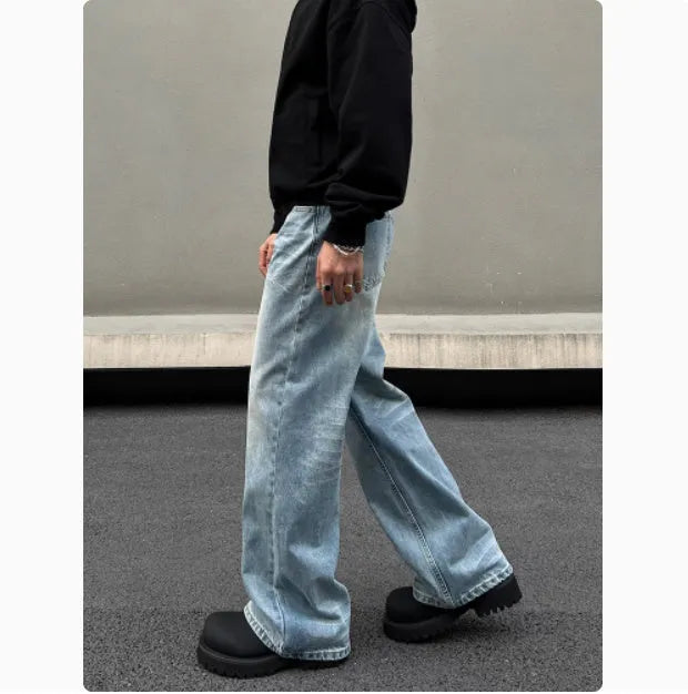 Men's blue straight leg jeans with whisker washing and flared leg style on medium-high waist