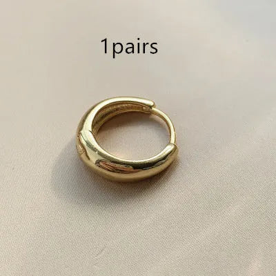 Women's minimalist water drop earrings in gold or silver with geometric round shape