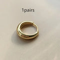 Women's minimalist water drop earrings in gold or silver with geometric round shape