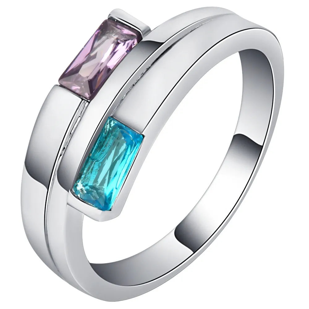 Silver electroplated copper ring with a zircon inlay, shown in a unisex design.