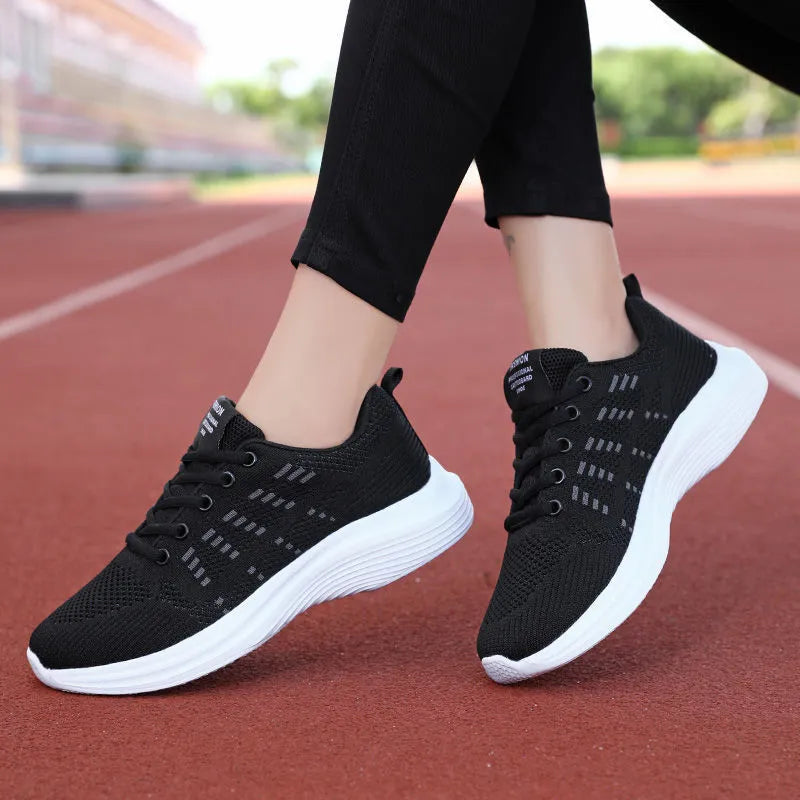 Women's black mesh breathable non-slip sneaker with lace-up front and flat heel, side view