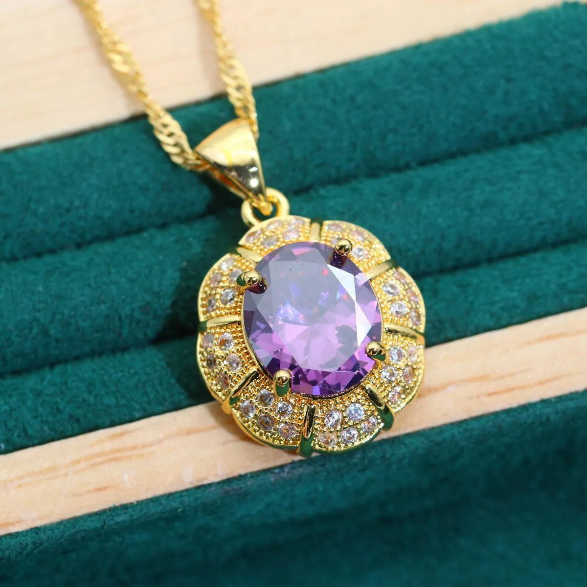 Gold-coloured jewellery set with coloured cubic zirconia stones, showing necklace, earrings, ring, and bracelet.