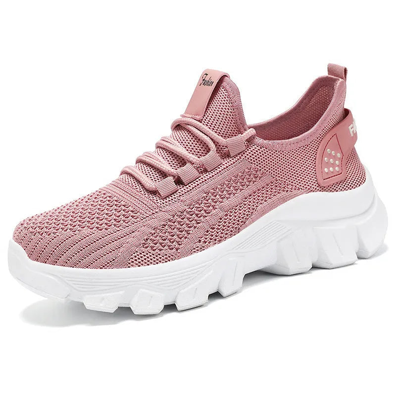 Women's white Flyknit sneakers with round toe and flat heel on a thick PVC sole.