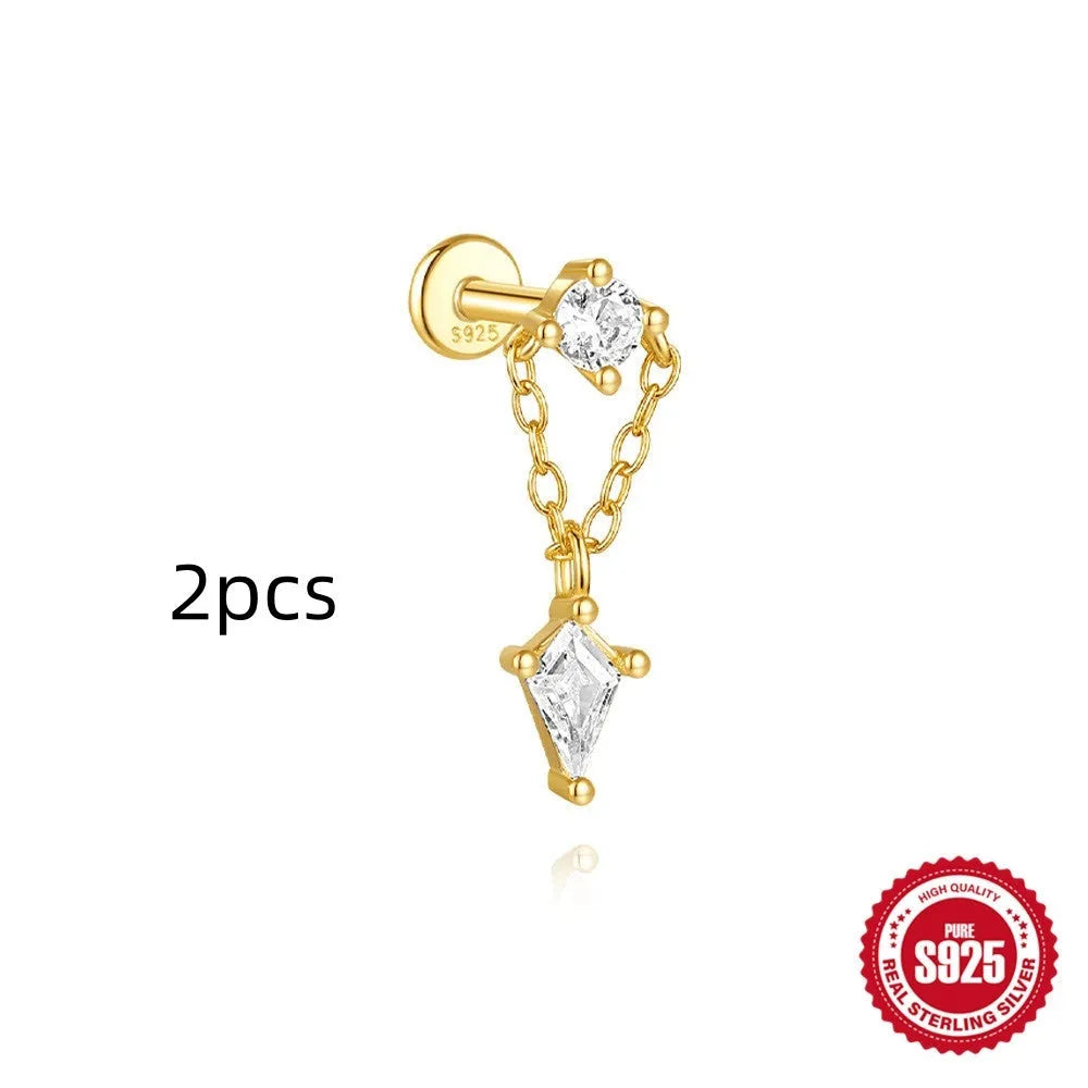 Geometric kite-shaped sterling silver stud earrings with rhinestones and a gold chain tassel.
