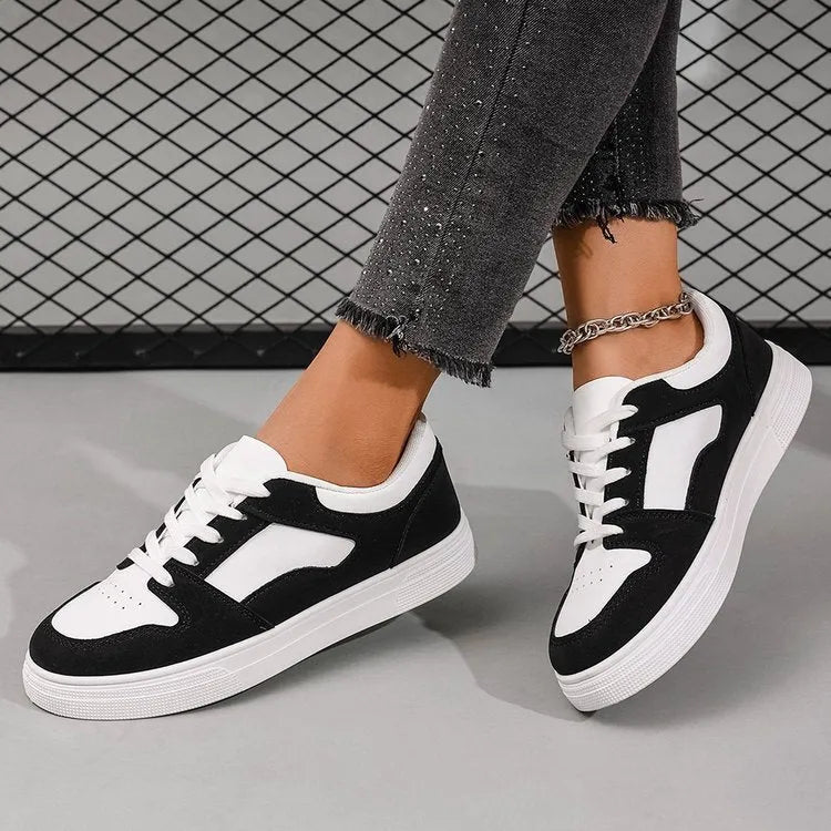 Black women's lace-up casual trainers with a round toe, low top, and rubber sole.