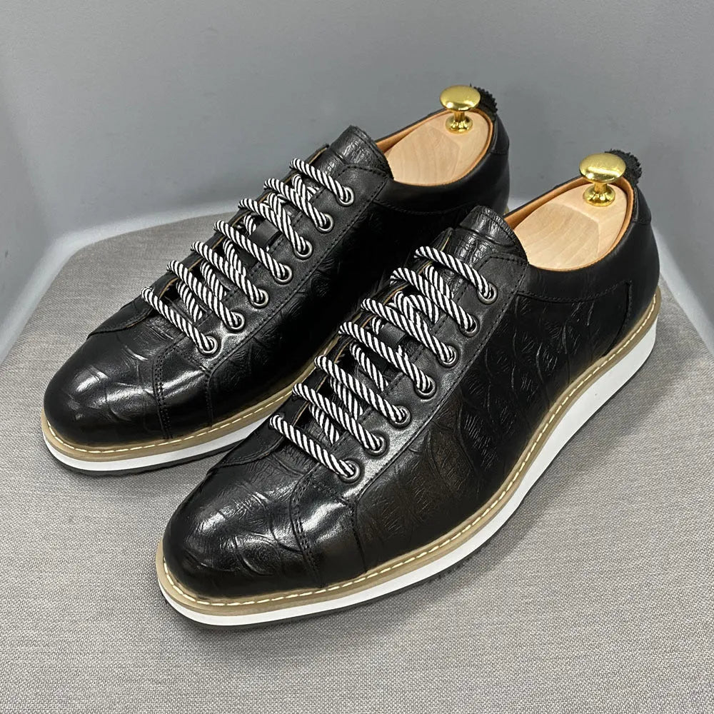 Low-top handmade men's shoes with an embossed pattern, shown in a choice of colours including black and green.