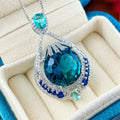 Geometric women's necklace with blue crystal fireworks cut pendant on water wave chain