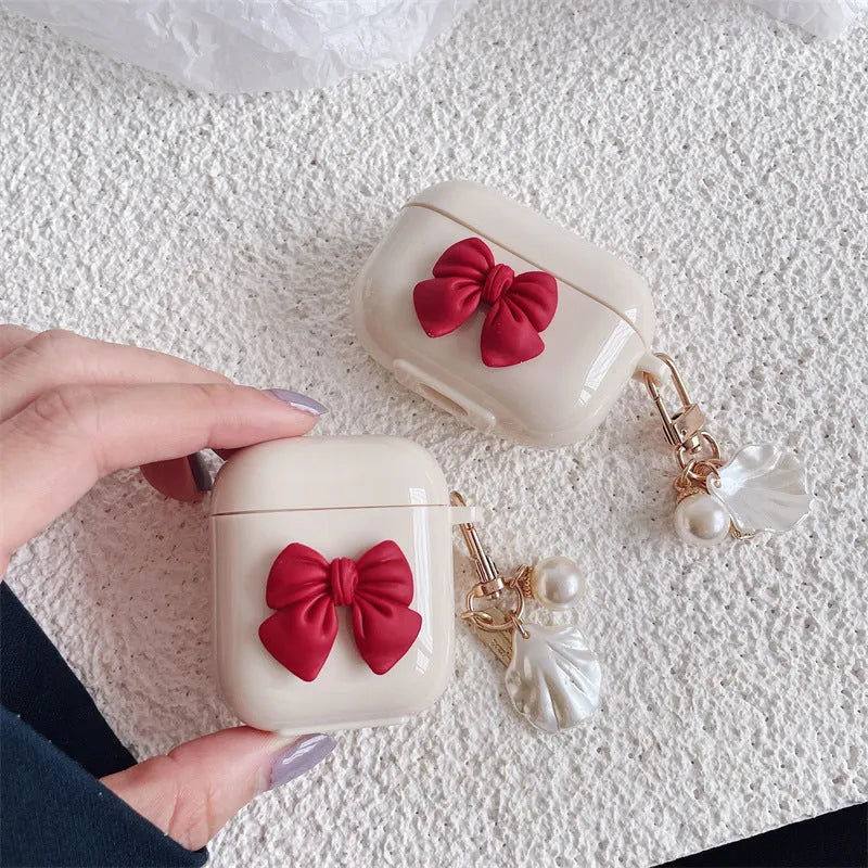 Beige red bow shell TPU protective case cover for AirPods showing clamshell design