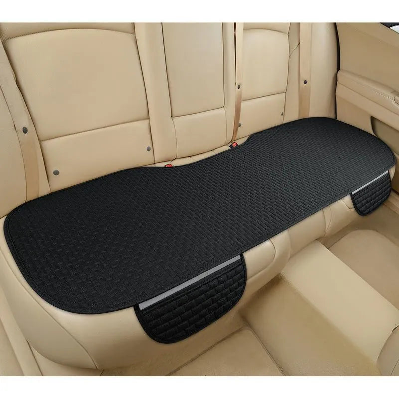 Linen car seat cushion in charm coffee colour, showing hemming detail, on a car seat.