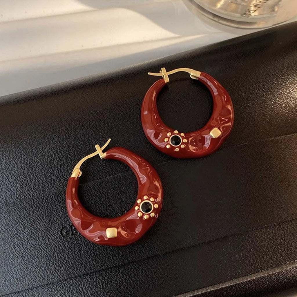 Black and red alloy ear studs with rhinestone inlays and dripping oil textured surface