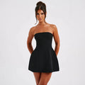 Women's black backless tube dress with short A-line skirt on a hanger.