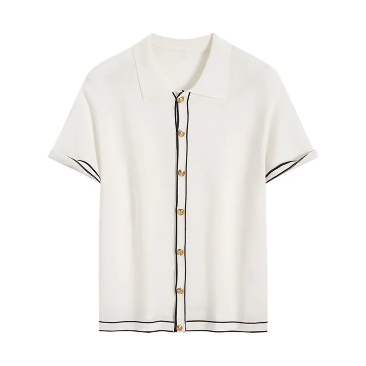 White cardigan with dark contrast lapels and short sleeves, laid flat.