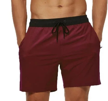 Men's blue athletic shorts with a stitching waistband, drawstring, and side headband pocket.