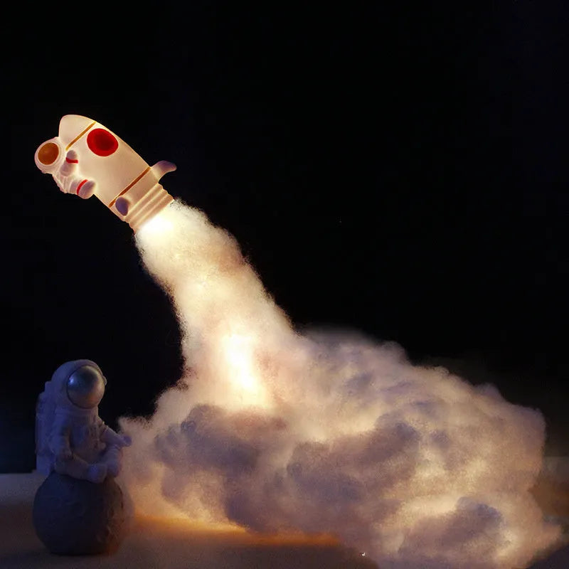 DIY astronaut rocket night light kit components including rocket model, LED string lights, straws, and chassis for assembly