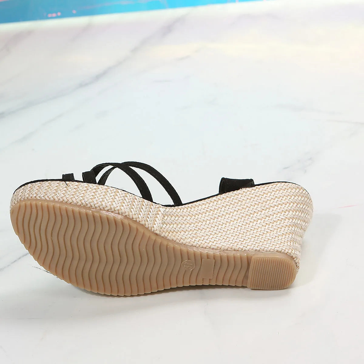 Women's beige wedge sandals with fish mouth toe and cloth upper, shown on a white background