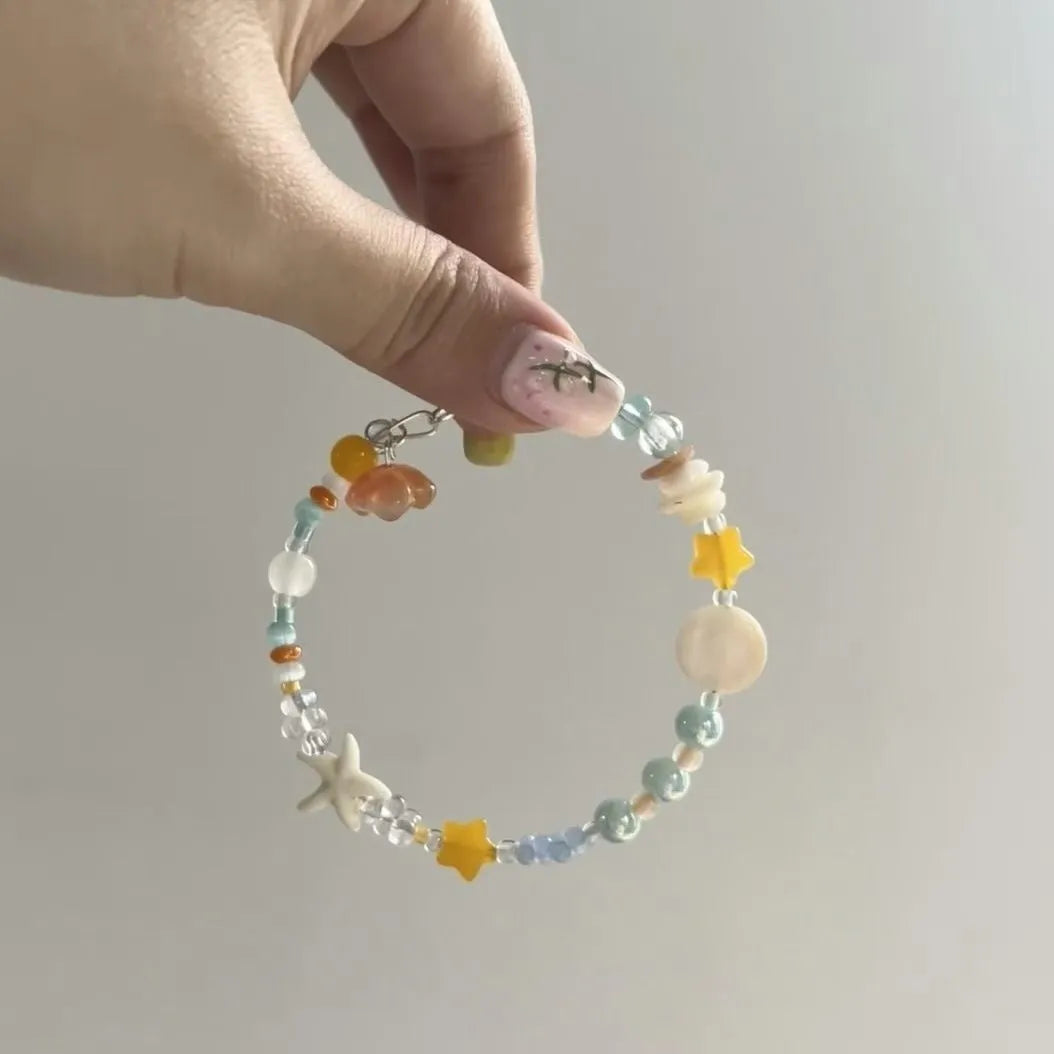 Orange alloy bracelet with diamond shape and round seawater-themed decorative elements
