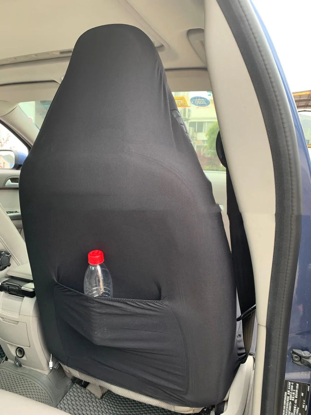 Black quilted automotive seat cover with plastic hooks for car interior protection