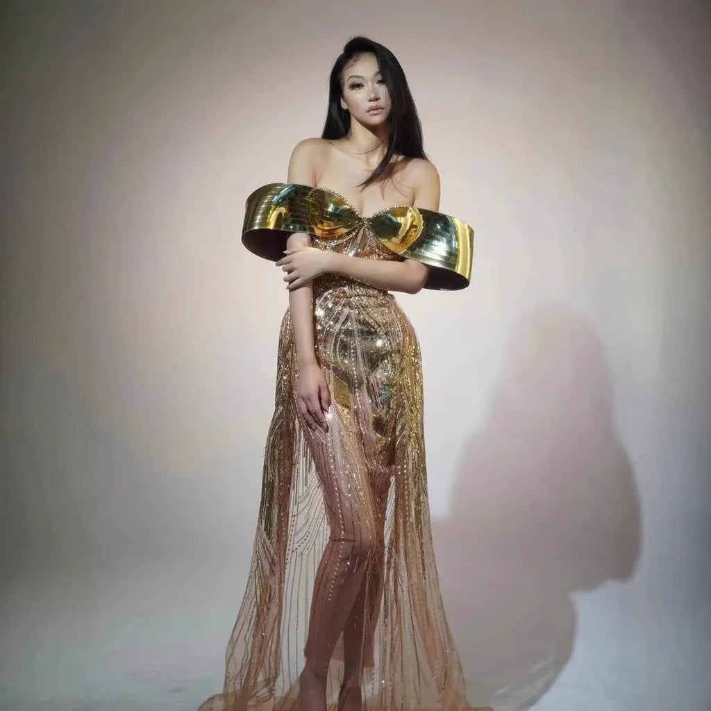 Gold strapless long dress with sequined tulle skirt and high side split, worn as formal evening wear.