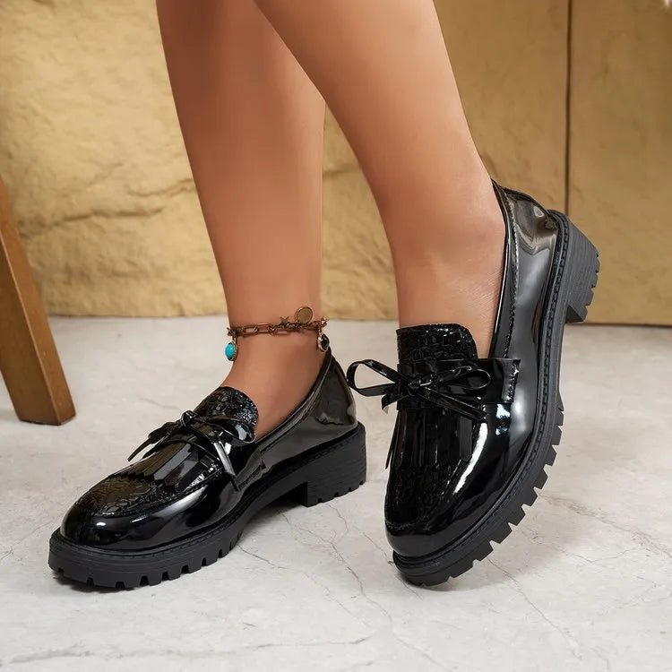Brown women's flat loafers with a decorative bow and elastic slingback.