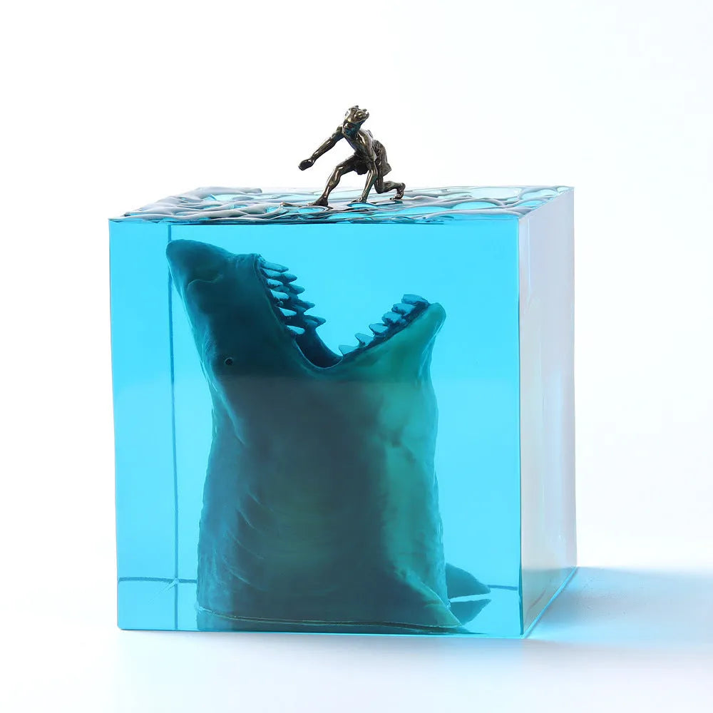 Epoxy resin shark surfer night light ornament on a desk with glowing micro landscape.