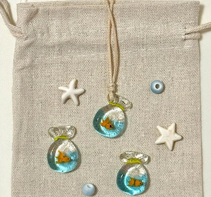 Women's necklace with a coloured glaze Small Fish Lucky Bag pendant on a cotton and linen clavicle chain.