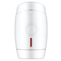 White home IPL laser hair removal device on a table showing its compact size and control buttons.