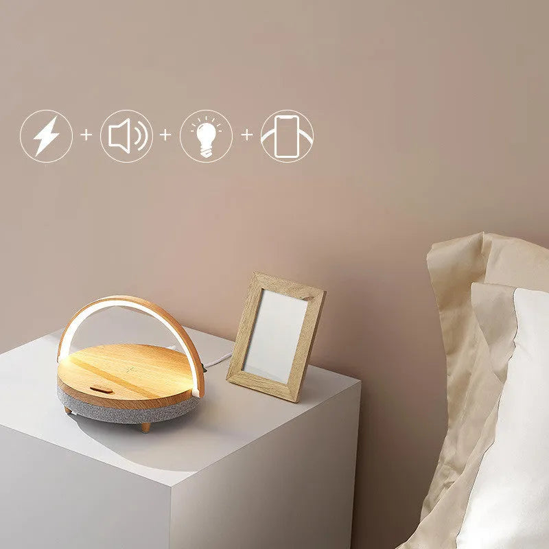 Wood grain finish wireless charging LED desk lamp with Bluetooth speaker and integrated phone holder.