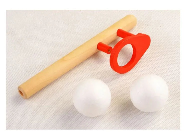 Wooden blowing balls magic suspension toy in red colour, 14 x 6 cm, on a white background