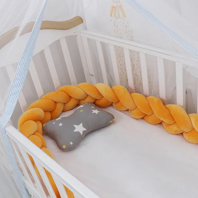 Multi-colour baby crib bumper made of spandex velvet, shown bent around a crib edge.