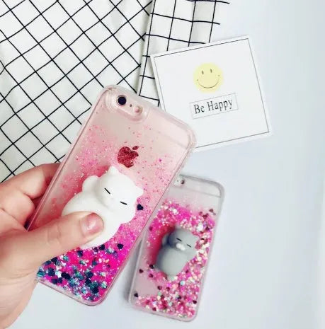 Four glittery cat design phone cases for iPhone models 6 to X on a table.
