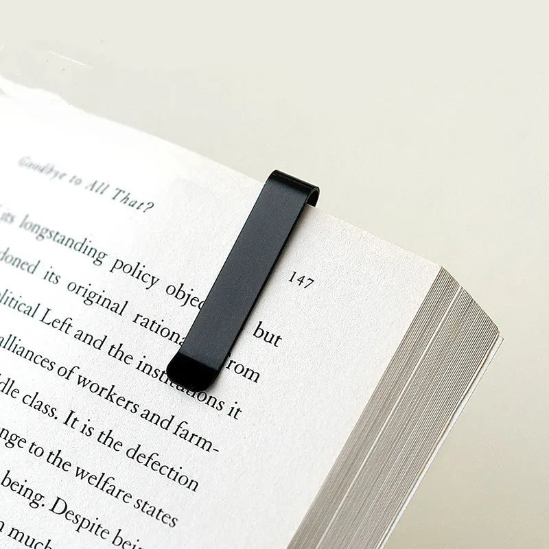 RUMA black and silver aluminium bookmark ruler showing 15cm laser-engraved scale.