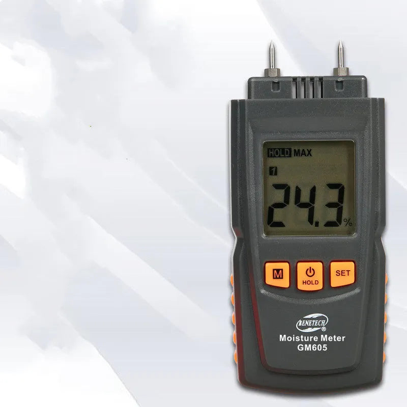 GM605 pin type wood moisture meter with black plastic casing and backlit LCD display