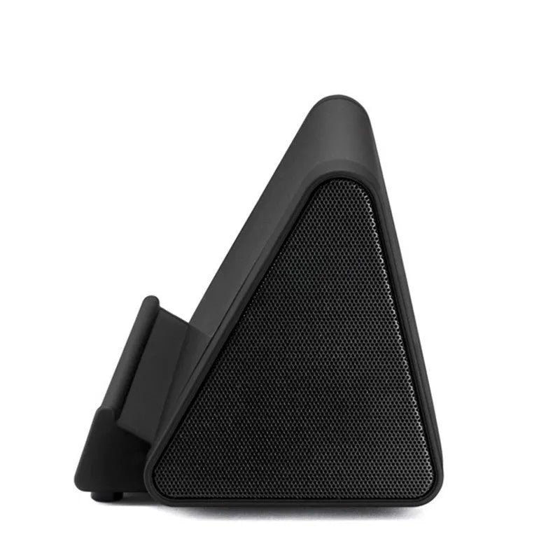 Compact black and white wireless Bluetooth mini speaker with charging cable.
