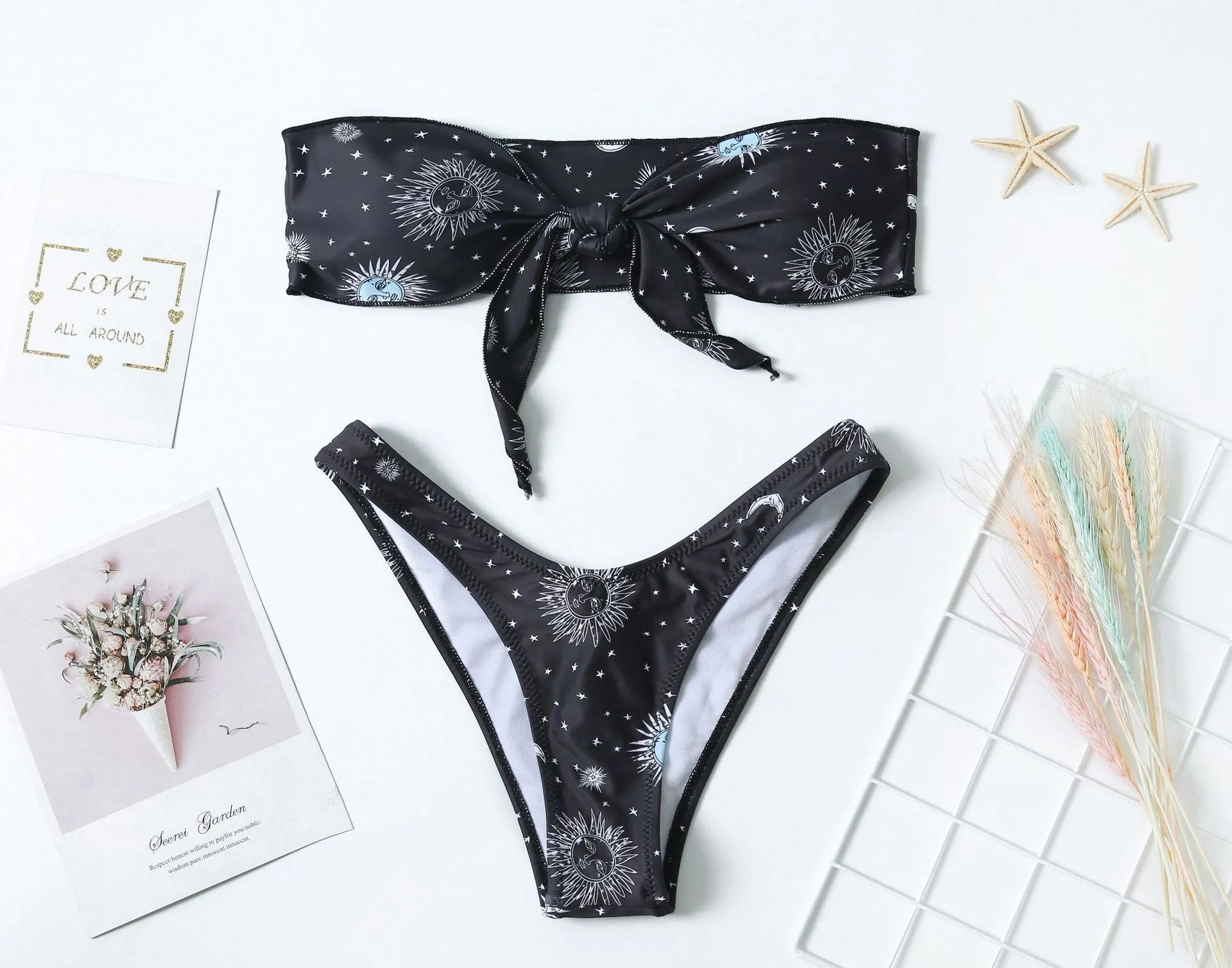 Black women's one-piece swimsuit with colourful bikini print and backless design