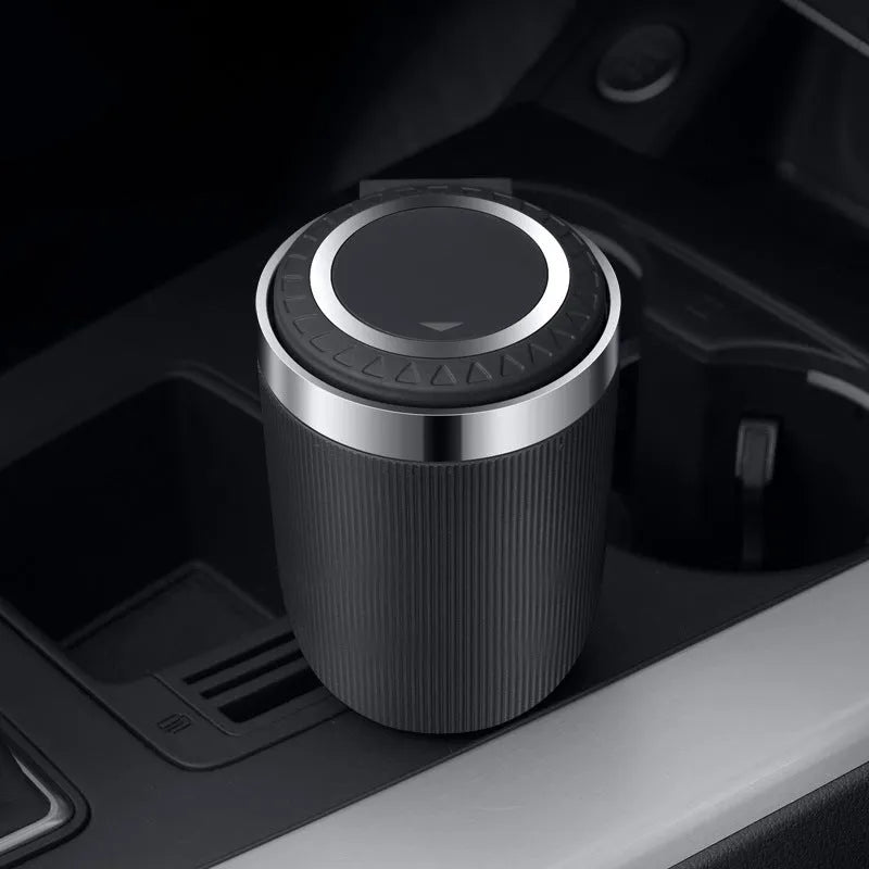 Metal ABS car ashtray with cover and blue LED light against a dark background