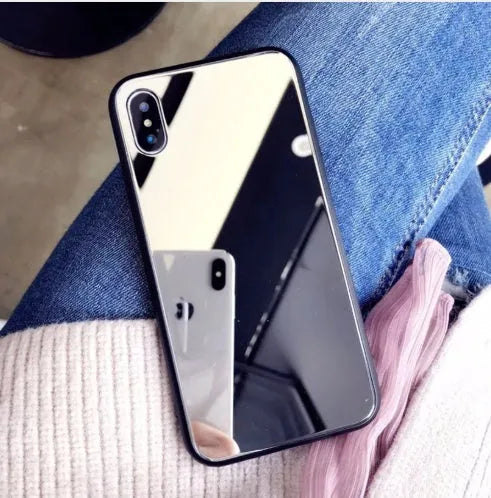 Black iPhone case with a built-in mirror on the back, compatible with iPhone X and iPhone 7 Plus models.